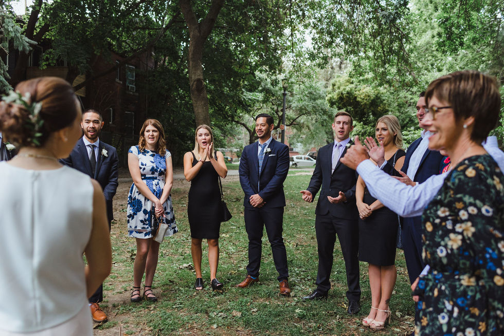 wedding guests celebrating the ceremony in Trinity Bellwoods Park Toronto