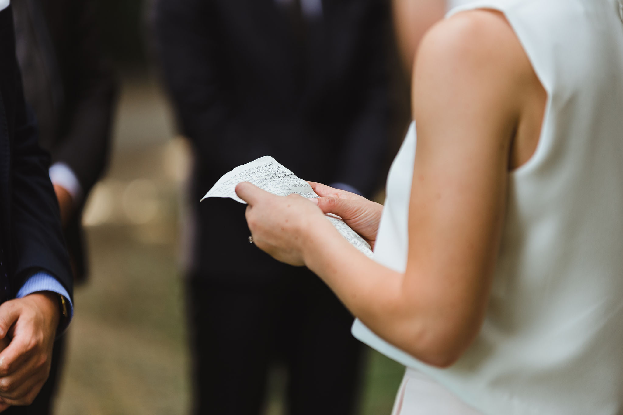 bride holding her nuptials written on a piece of white paper Trinity Bellwoods wedding Toronto