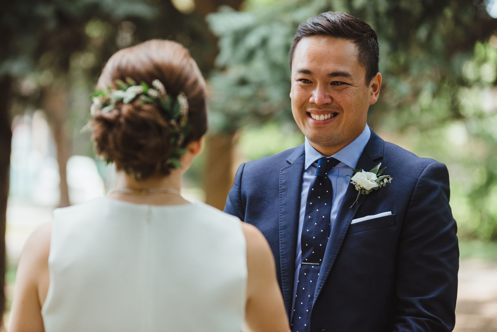 groom smiling at his bride during wedding ceremony in Trinity Bellwoods Park Toronto