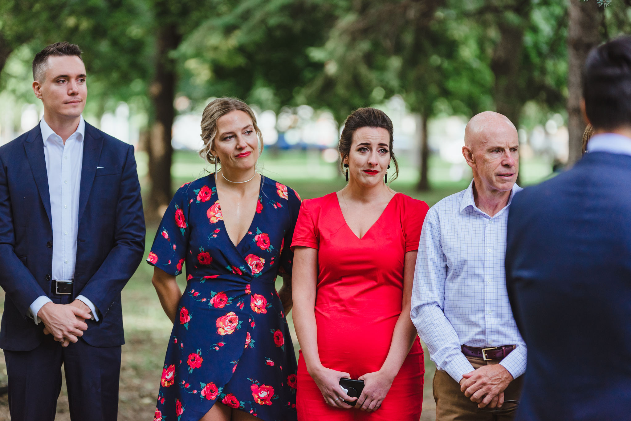 wedding guests tearing up during ceremony in Trinity Bellwoods Park Toronto