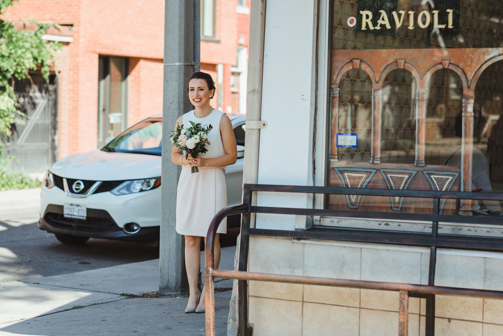 bride walking around the corner holding bouquet of flowers Toronto Ontario wedding photographer