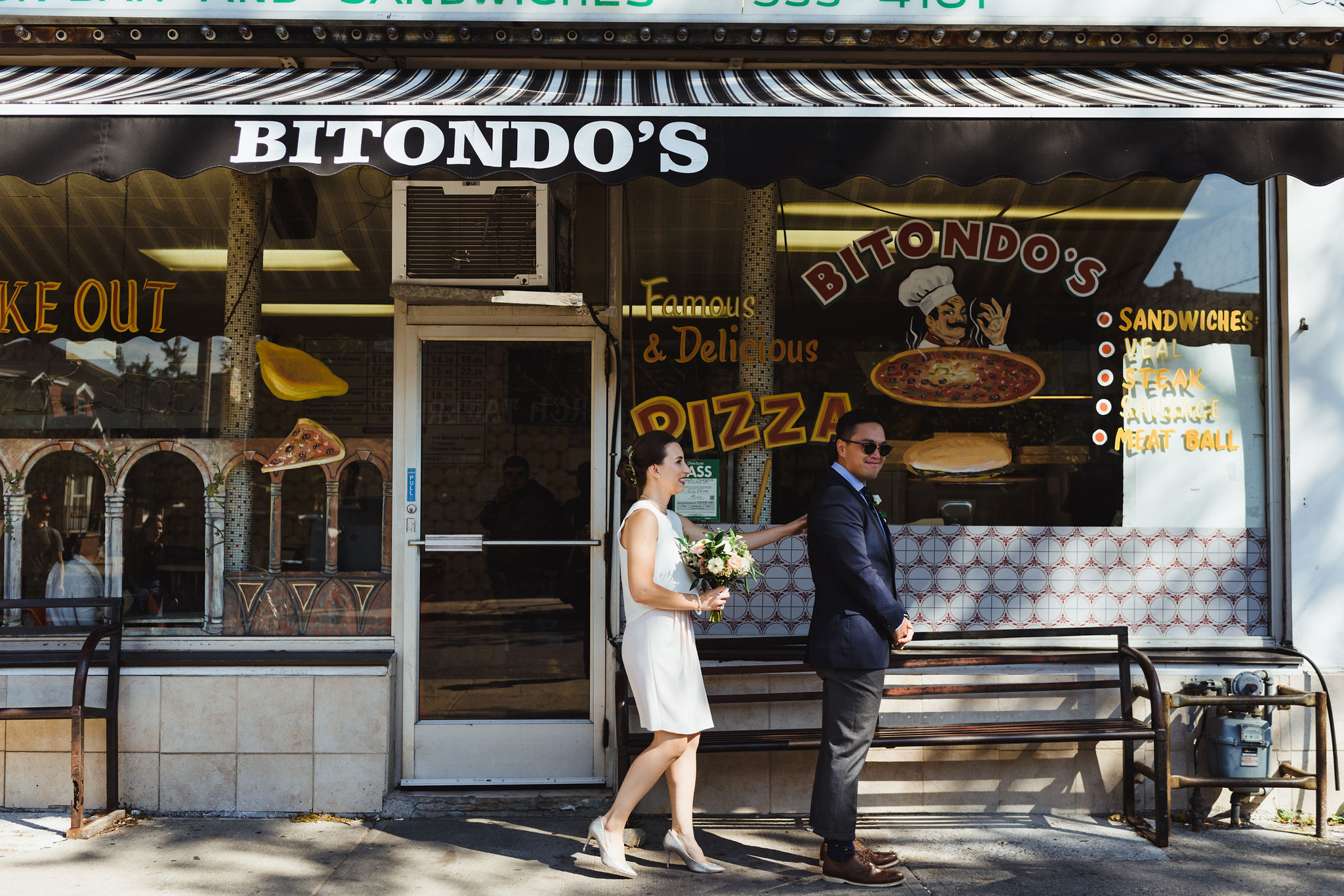 bride placing her hand on her groom for first look in front of Bitondo's Pizzeria Toronto Canada 