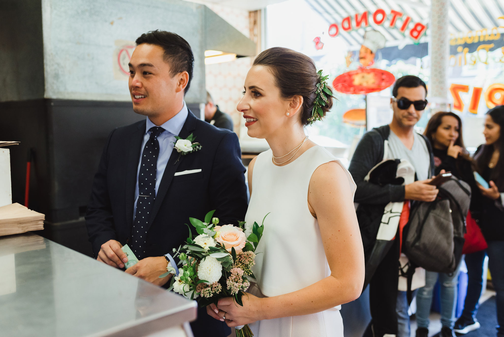 bride and groom ordering a pizza at Bitondo's Pizzeria Toronto Canada wedding 