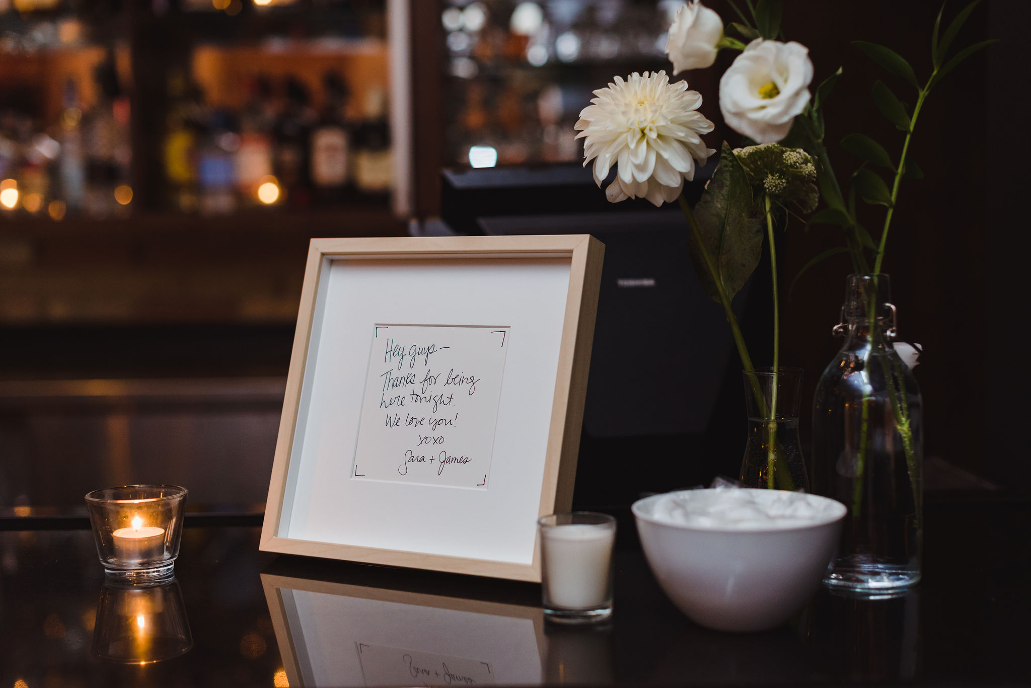 flowers, picture frame, and candles at wedding reception in the Gladstone Hotel Toronto wedding photographer Gillian Foster