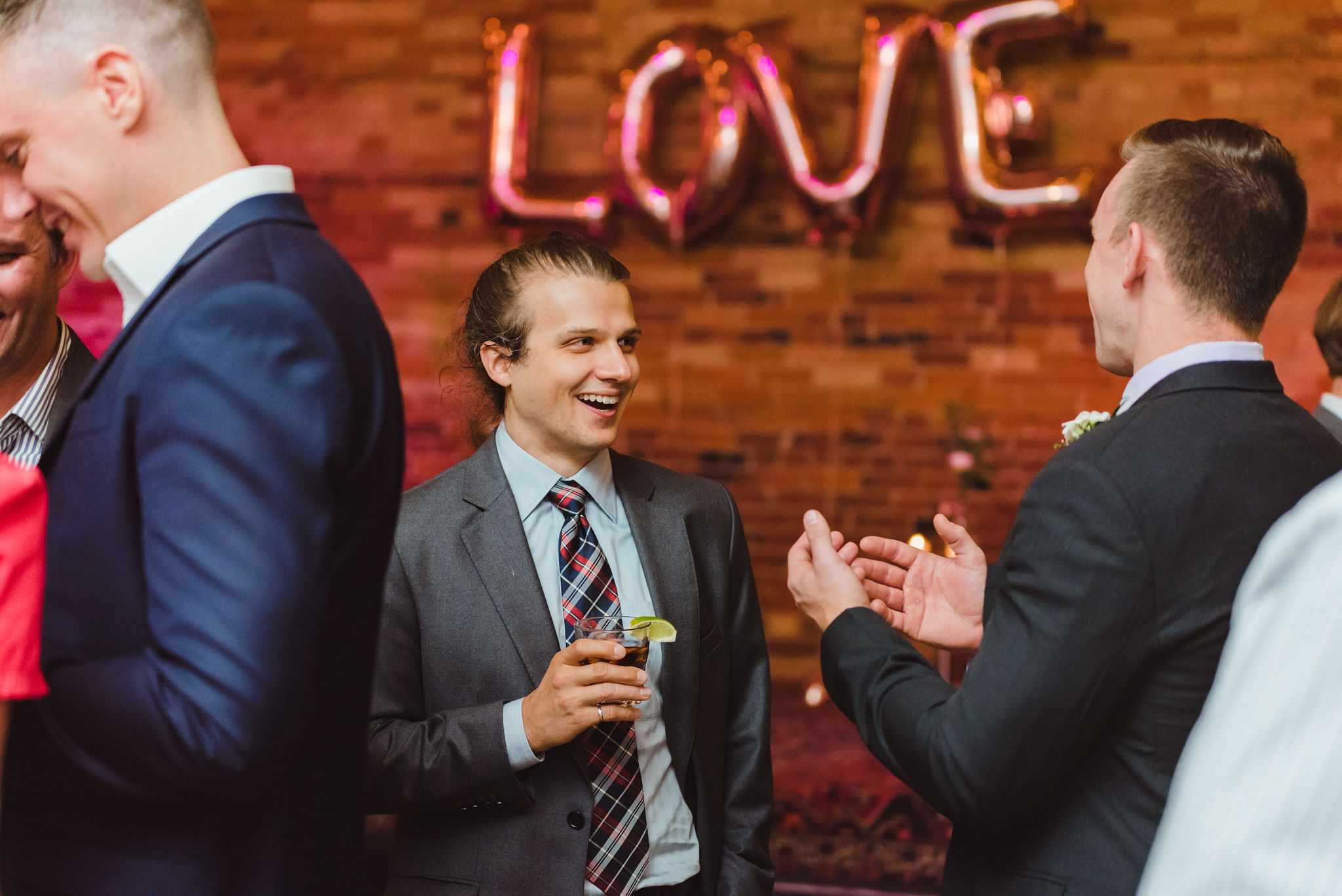 wedding guests chatting during reception with balloons spelling out LOVE behind them Gladstone Hotel wedding Toronto