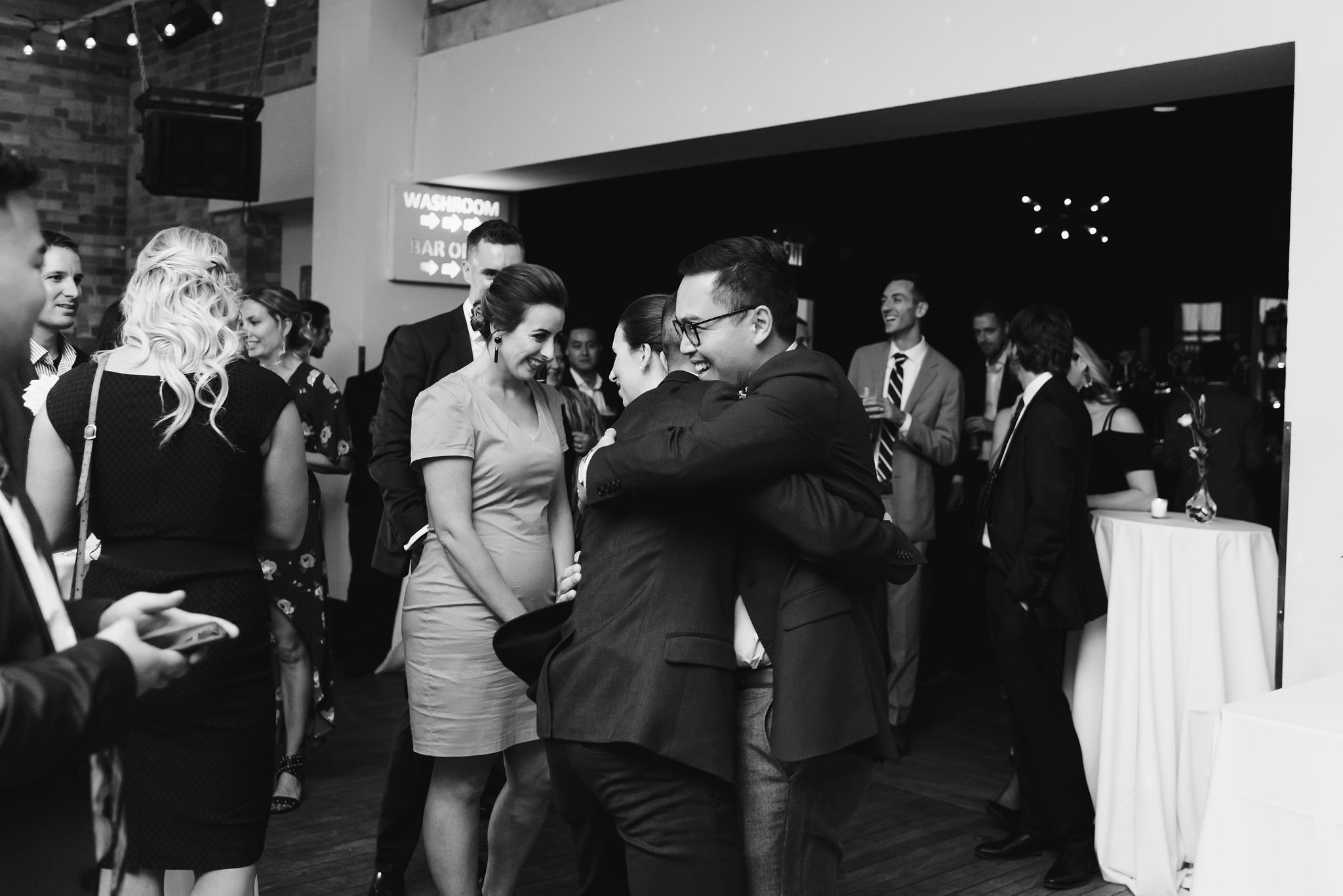 groom hugging a wedding guest during the reception at the Gladstone Hotel in Toronto