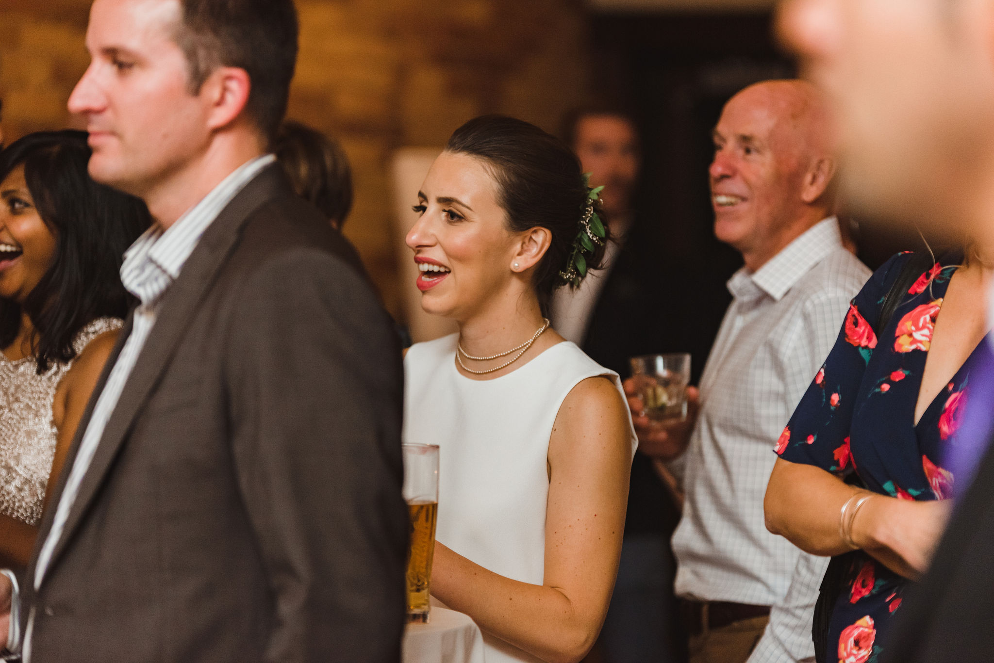 bride and wedding guests watching and smiling during speeches at the Gladstone Hotel in Toronto