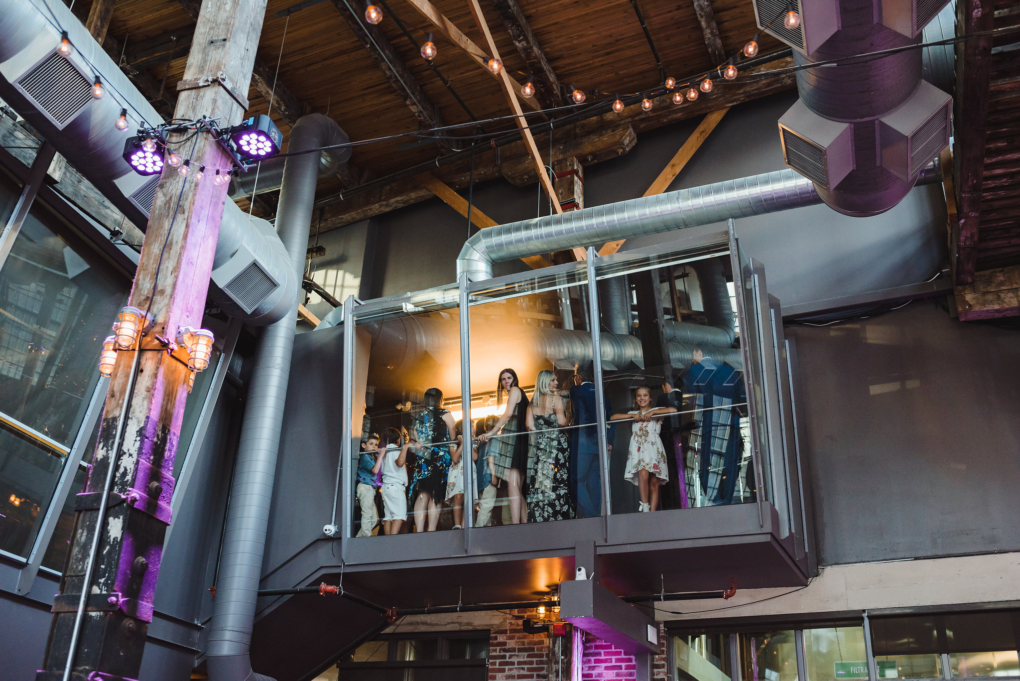 wedding guests overlooking venue from 2nd floor at Steam Whistle Brewing Toronto Canada 