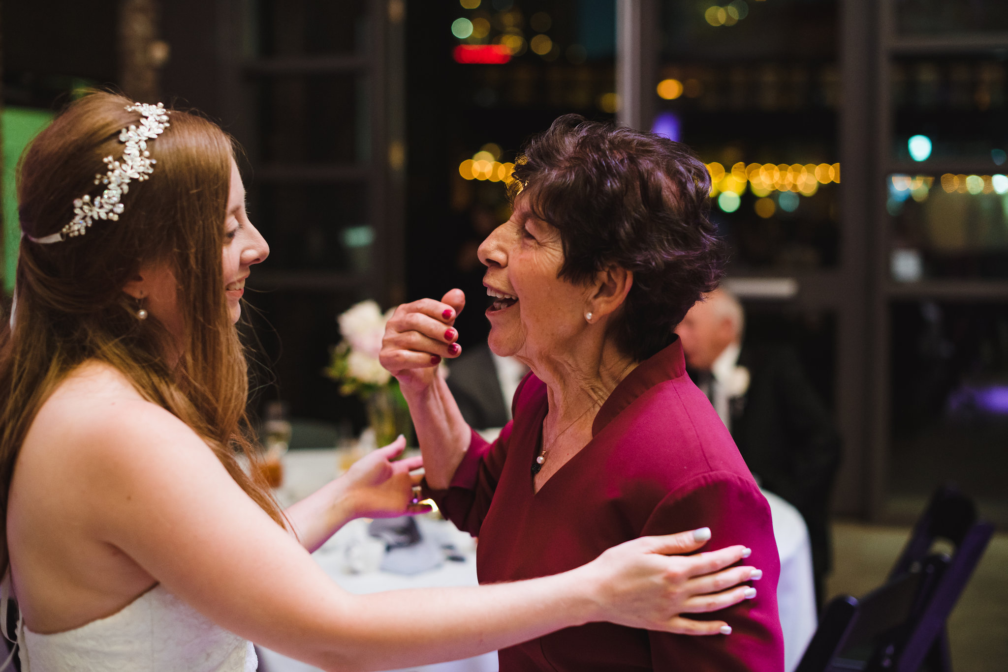 bride smiling at talking with wedding guest during her wedding at Steam Whistle Brewing