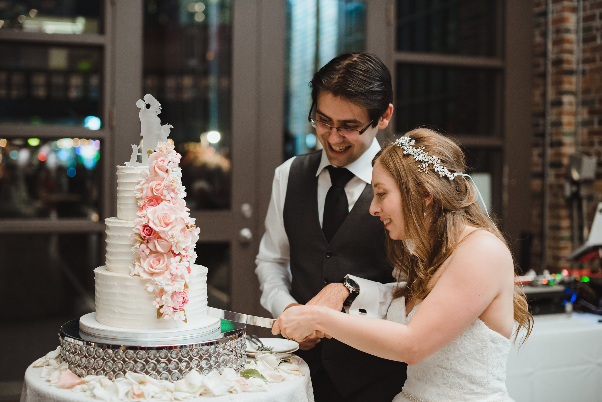 bride and groom cutting their wedding cake at Steam Whistle Brewing