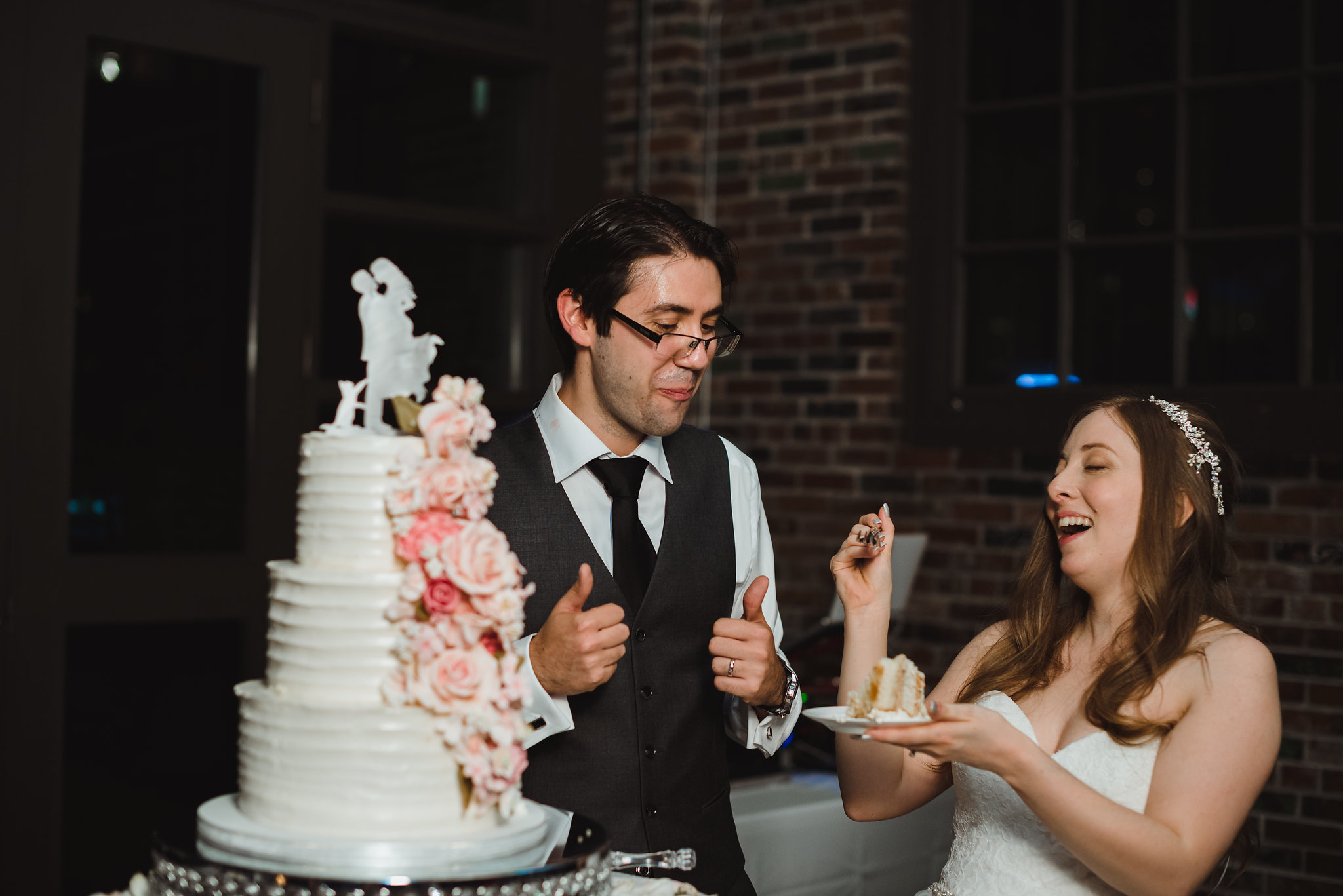 Bride and groom enjoying their wedding cake at Steam Whistle Brewing