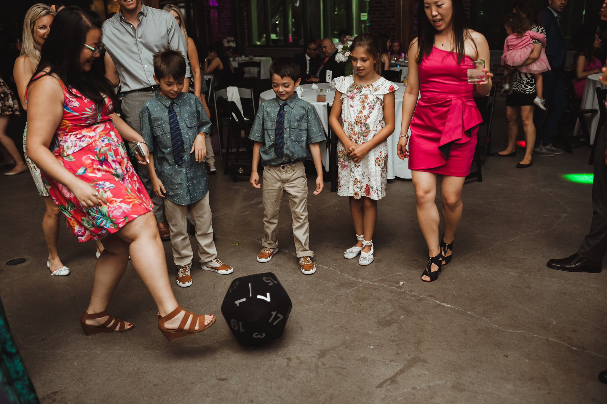 wedding guests kicking around oversized dice at Steam Whistle Brewing 