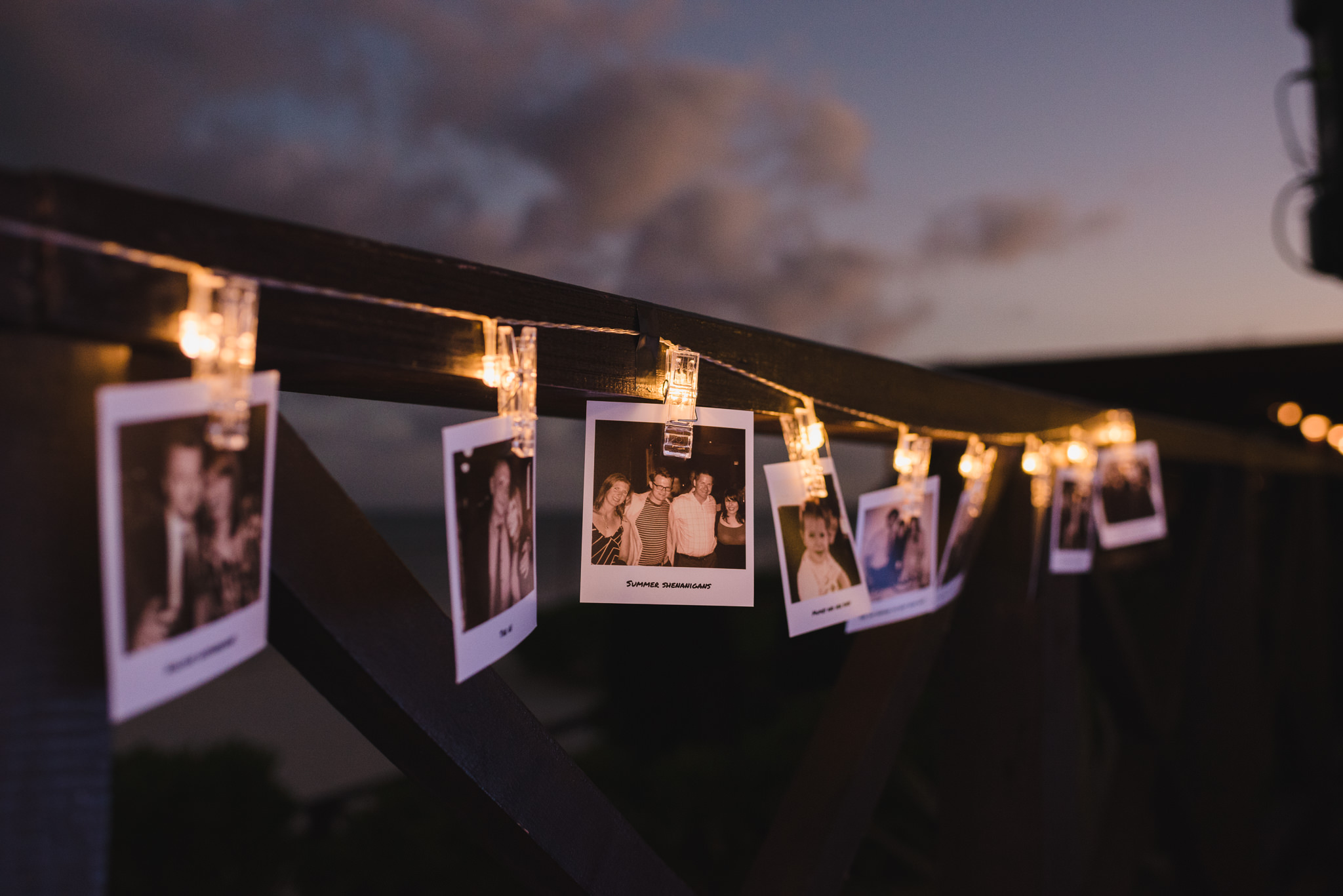 polaroids and lights strung up for wedding reception at Now Sapphire Resort in Mexico