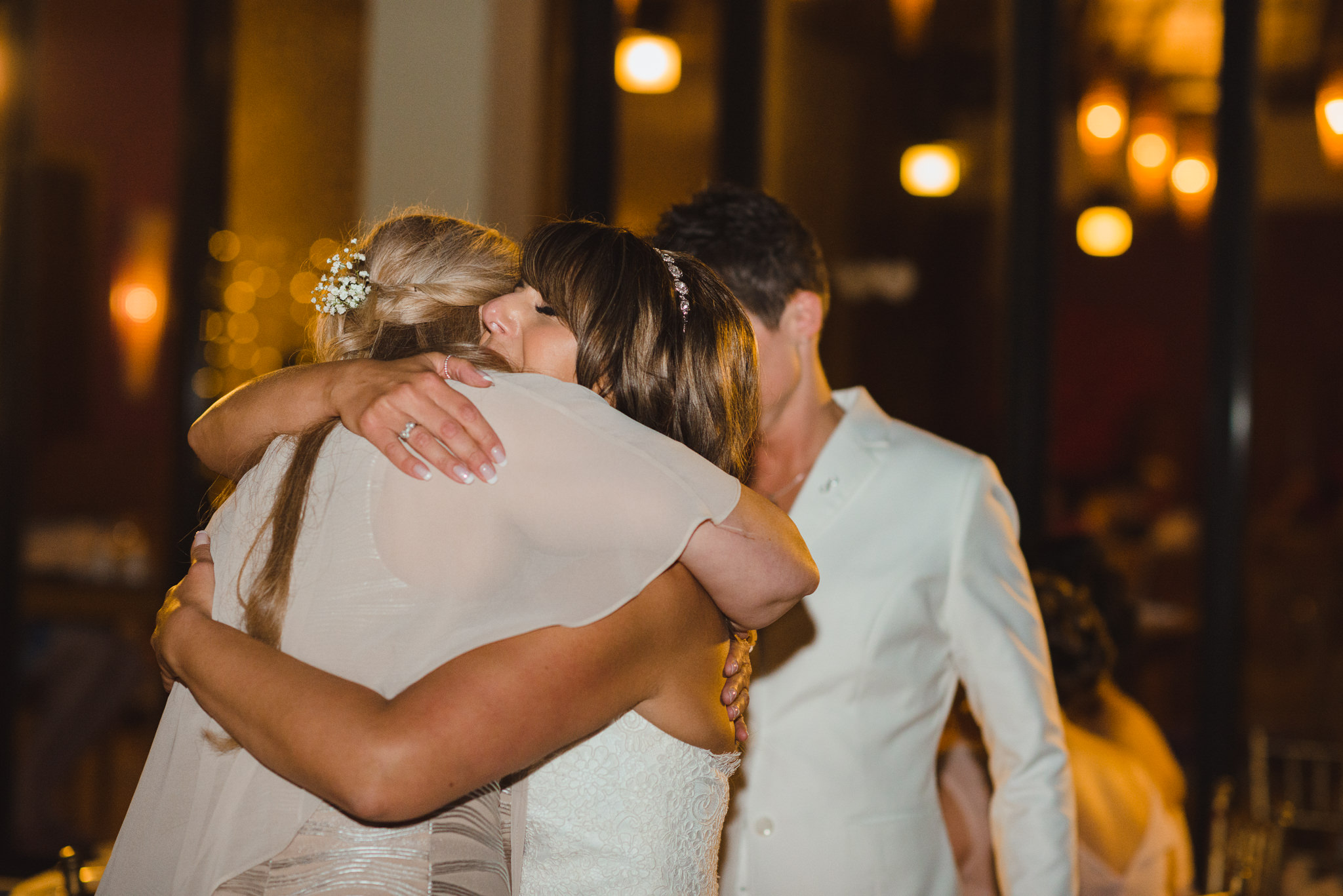 bride hugs a wedding guest during reception at Now Sapphire Resort in Mexico