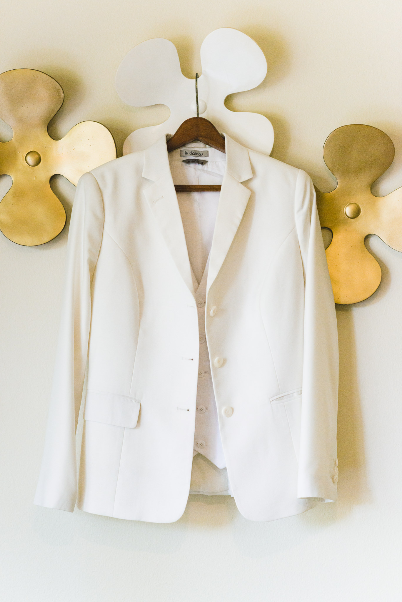 brides white wedding jacket hanging up on the wall at Now Sapphire Resort in Mexico