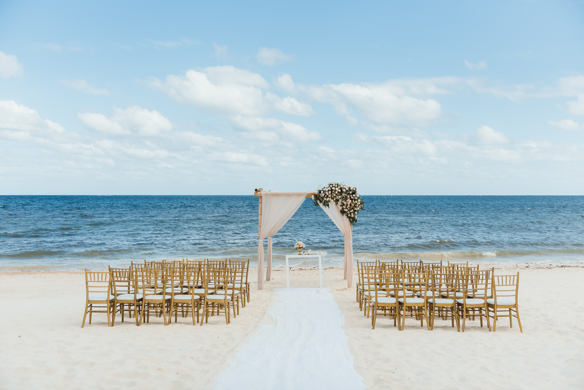 chairs and wedding alter set up on beach in front of the ocean at the Now Sapphire Resort in Mexico how to be really relaxed during your wedding 