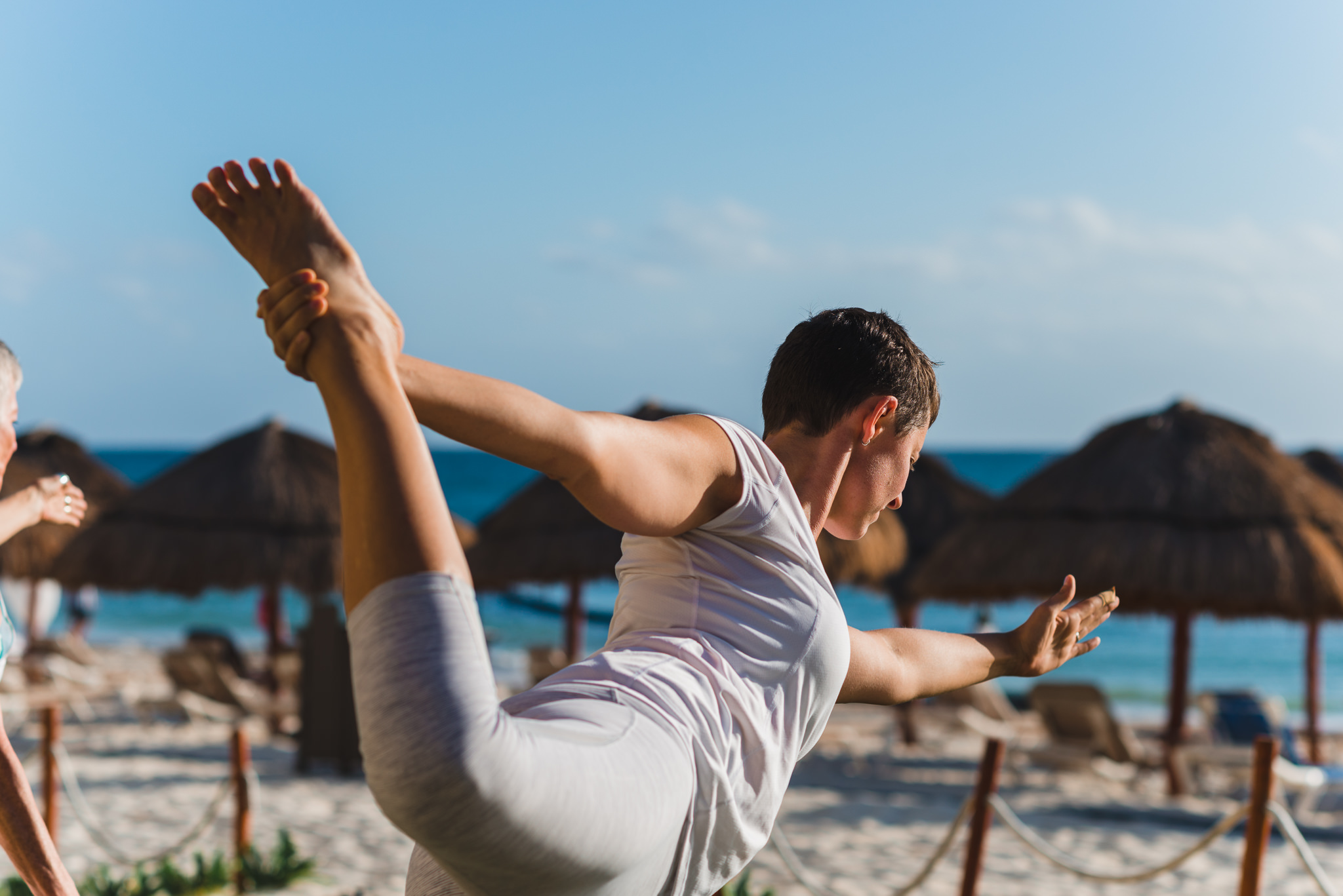 bride doing morning yoga on the beach at Now Sapphire Resort in Mexico