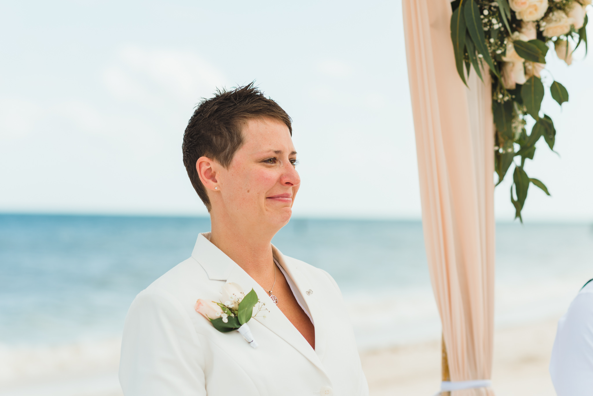bride smiling and crying at beach wedding ceremony at Now Sapphire Resort in Mexico
