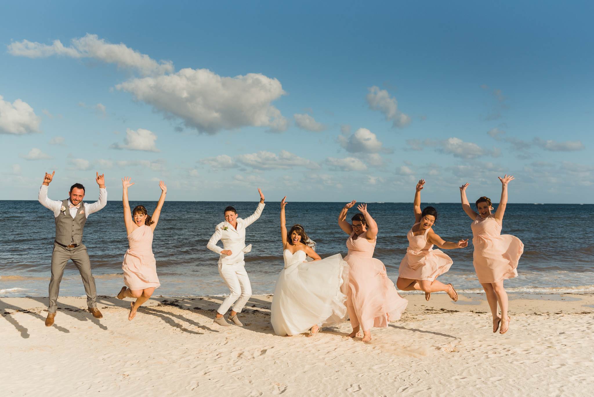 brides and their wedding party jumping in the air on the beach at the Now Sapphire Resort in Mexico how to be really relaxed during your wedding
