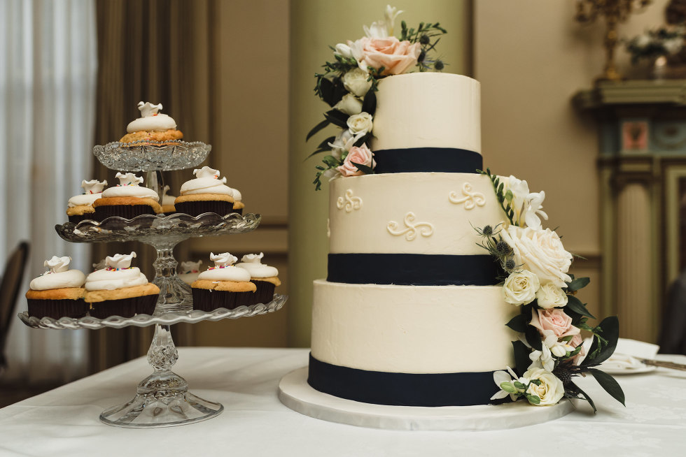 black and white wedding cake with flowers and cupcakes on a three-tiered serving tray University Club wedding downtown Toronto 