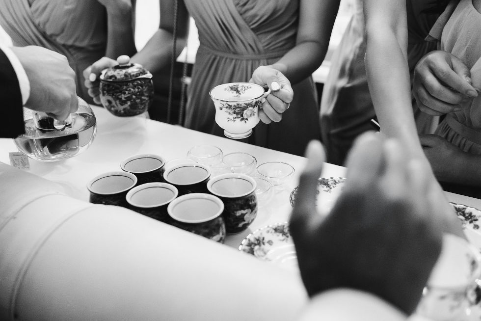 hand holding vintage tea cup pouring tea before wedding at Fantasy Farms in Toronto Ontario