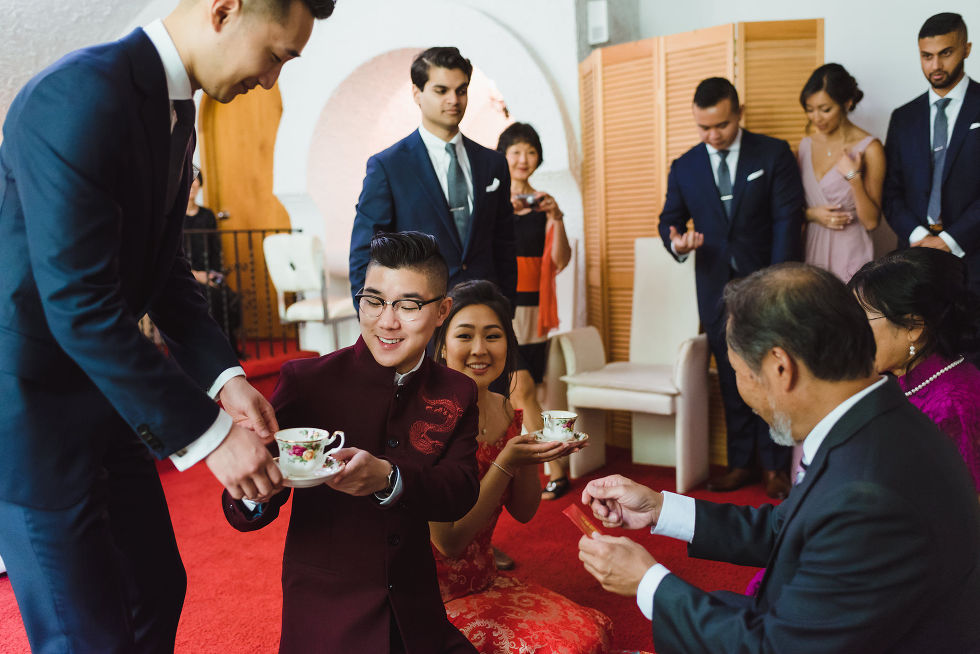traditional ceremony holding and passing tea cups at a wedding at Fantasy Farms in Toronto Ontario