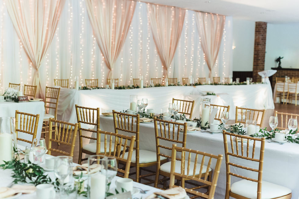 white curtains and linens with gold chairs for wedding venue at Fantasy Farms in Toronto Ontario