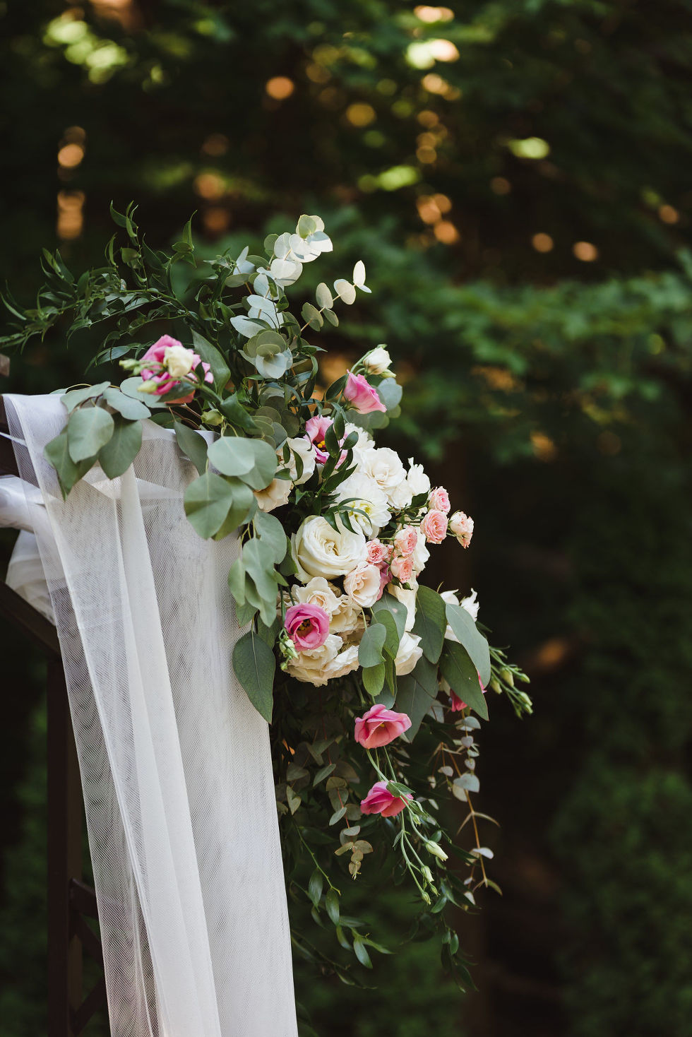 pink and white flowers with greenery bouquet perched on fence at Fantasy Farms in Toronto Ontario