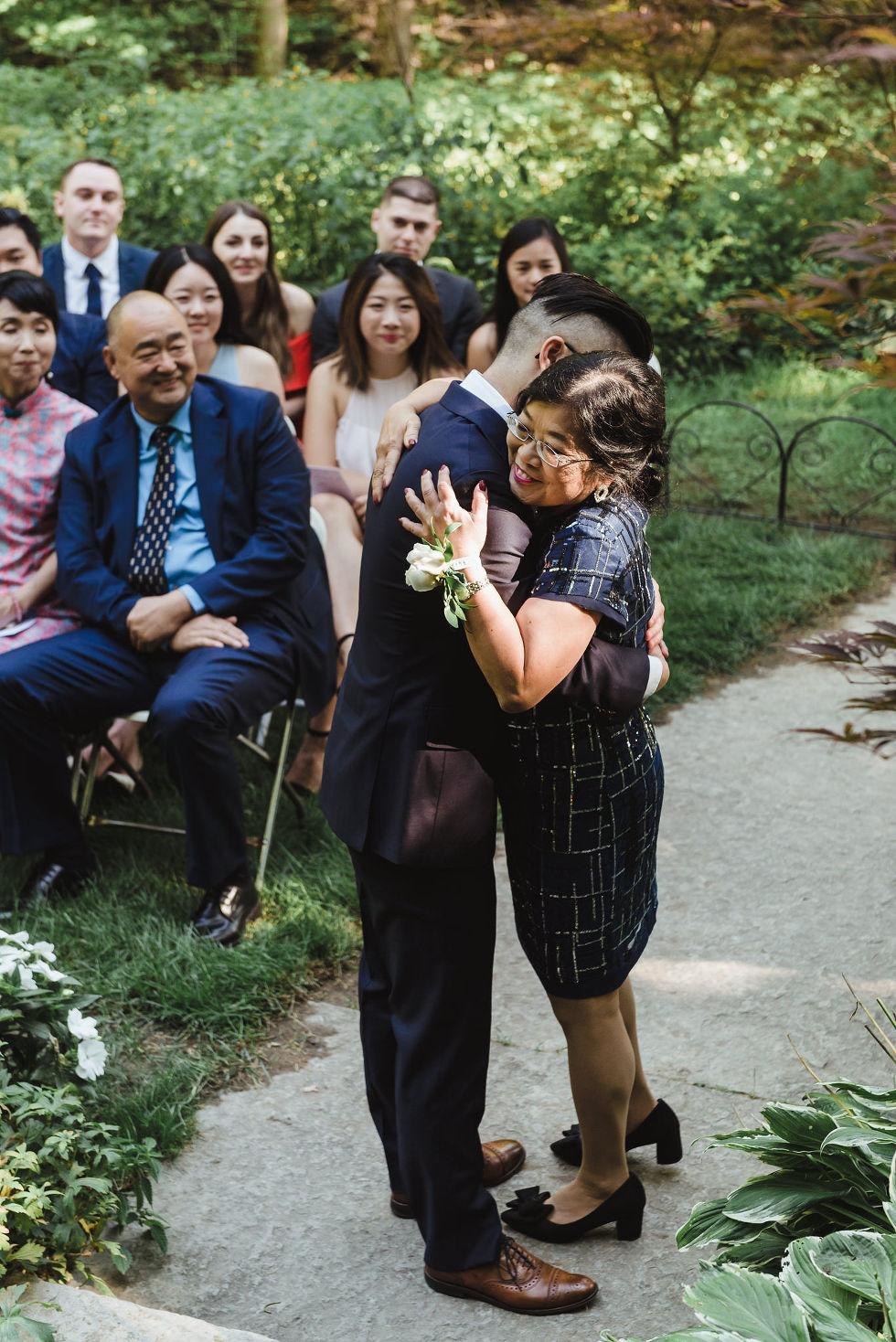groom hugging his mother at wedding outside at Fantasy Farms in Toronto Ontario
