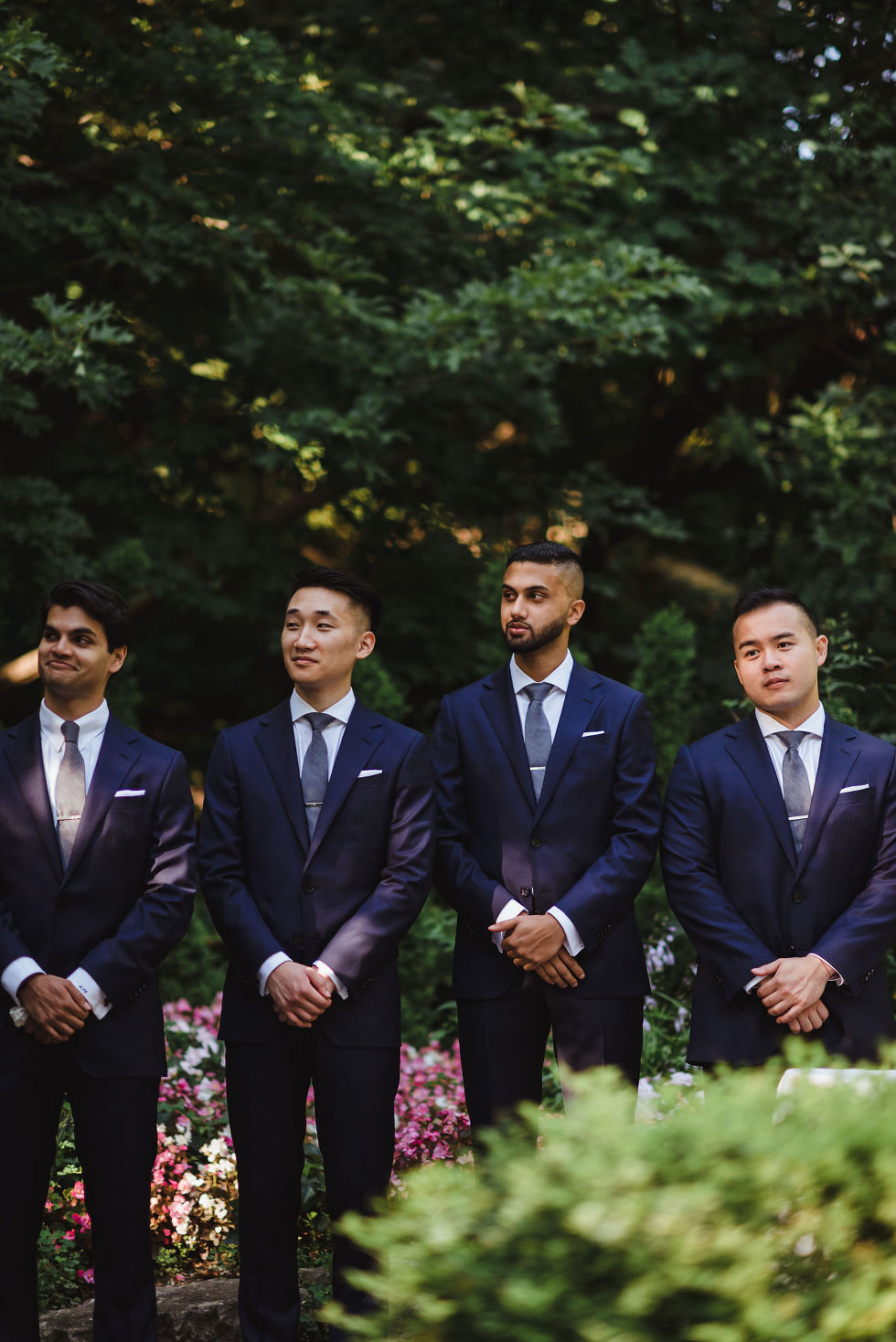 groomsmen standing in garden at Fantasy Farms in Toronto Ontario