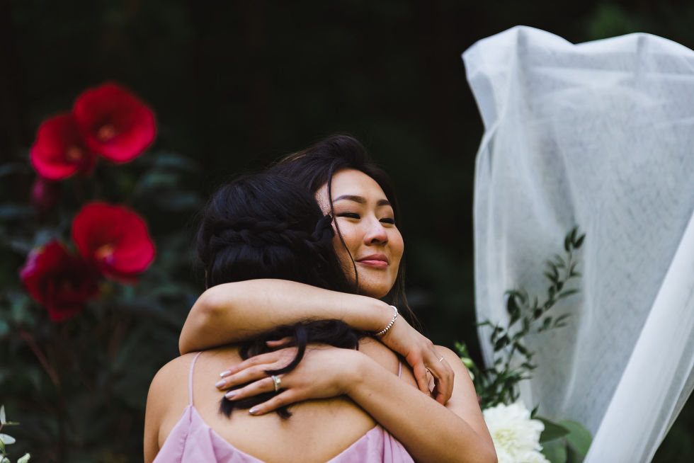 bride hugging bridesmaid wearing lavender coloured dress at Fantasy Farms in Toronto Ontario