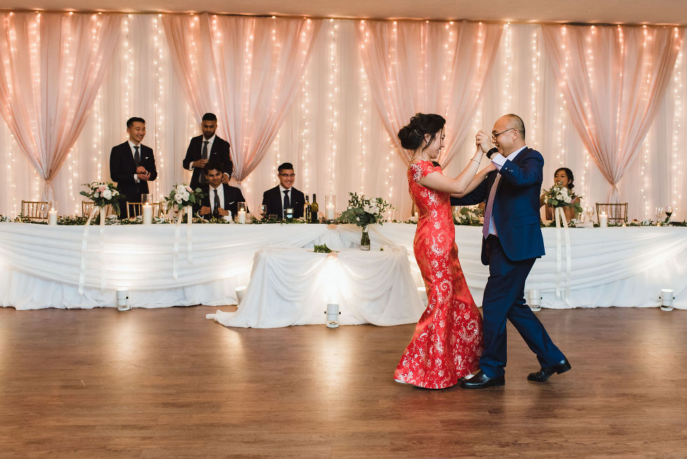 bride wearing a red dress dancing with her father at her wedding at Fantasy Farms in Toronto Ontario