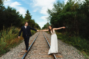 Bride and groom holding hands at Carvers cottage