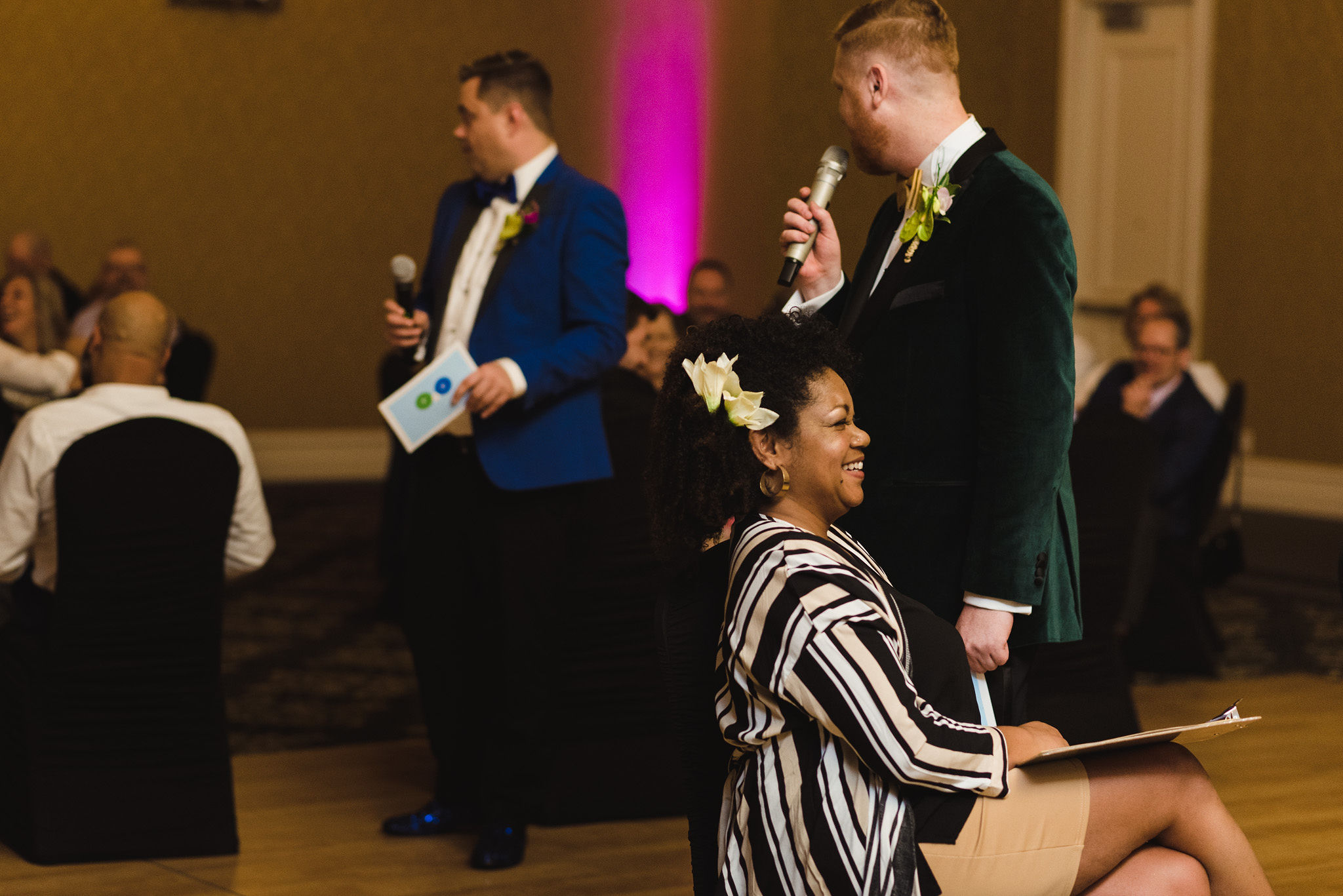grooms instructing guests about the rules for the game they planned for their fun wedding at the Hilton Fallsview in Niagara Falls