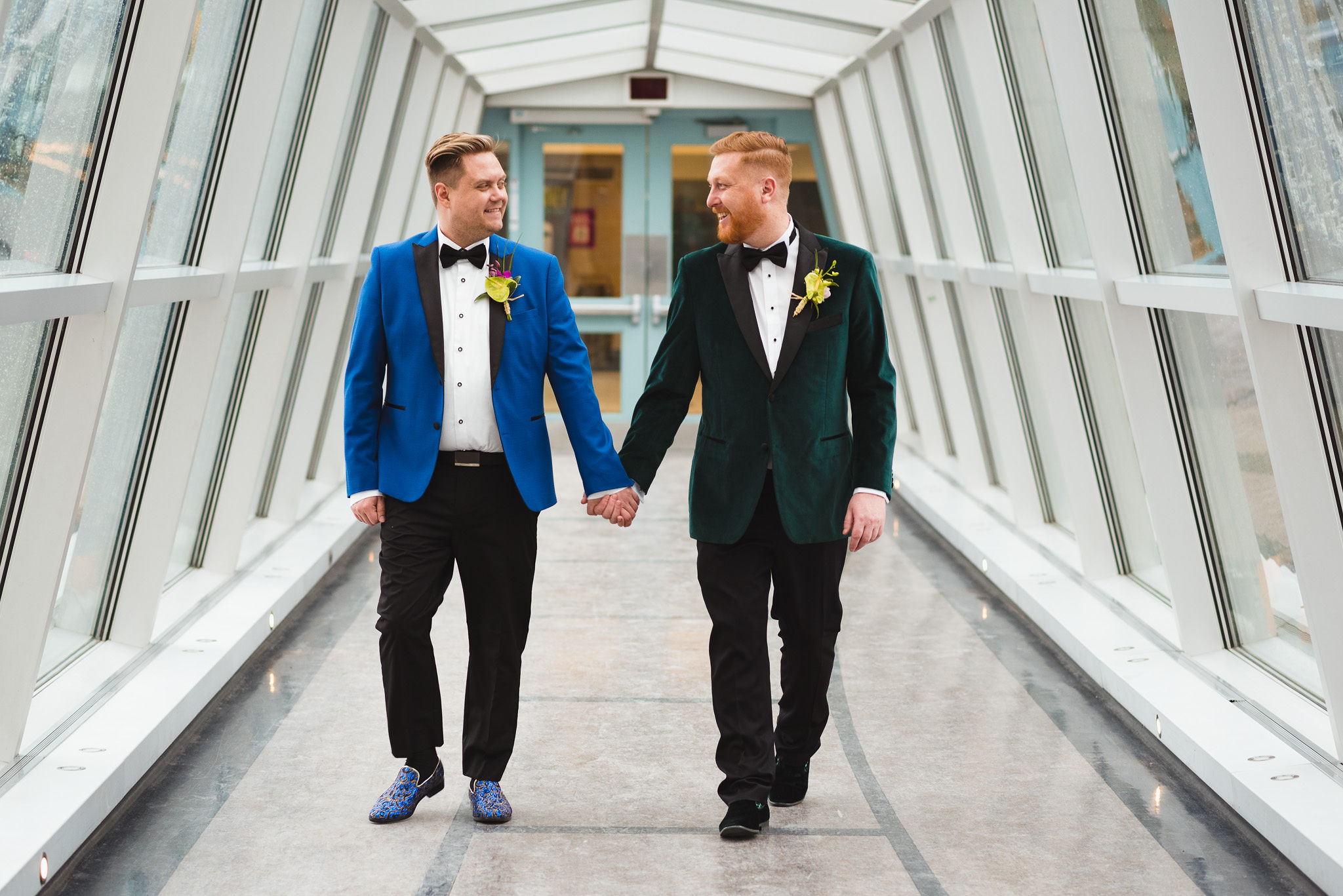 grooms strolling hand in hand before their wedding ceremony at the Hilton Fallsview in Niagara Falls