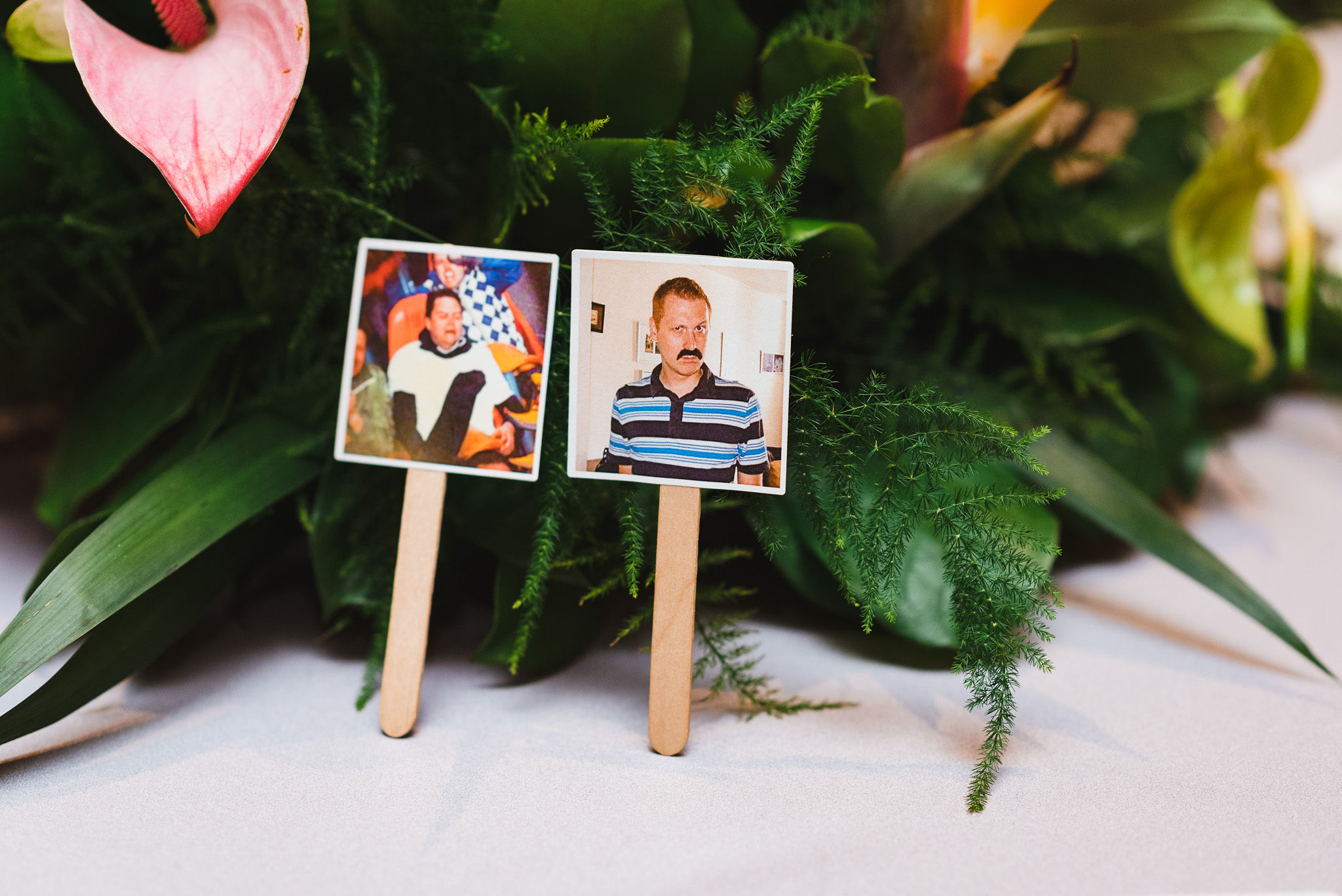 pictures of the grooms printed on paper and stuck to popsicle sticks on the table during wedding ceremony at the Hilton Fallsview in Niagara Falls