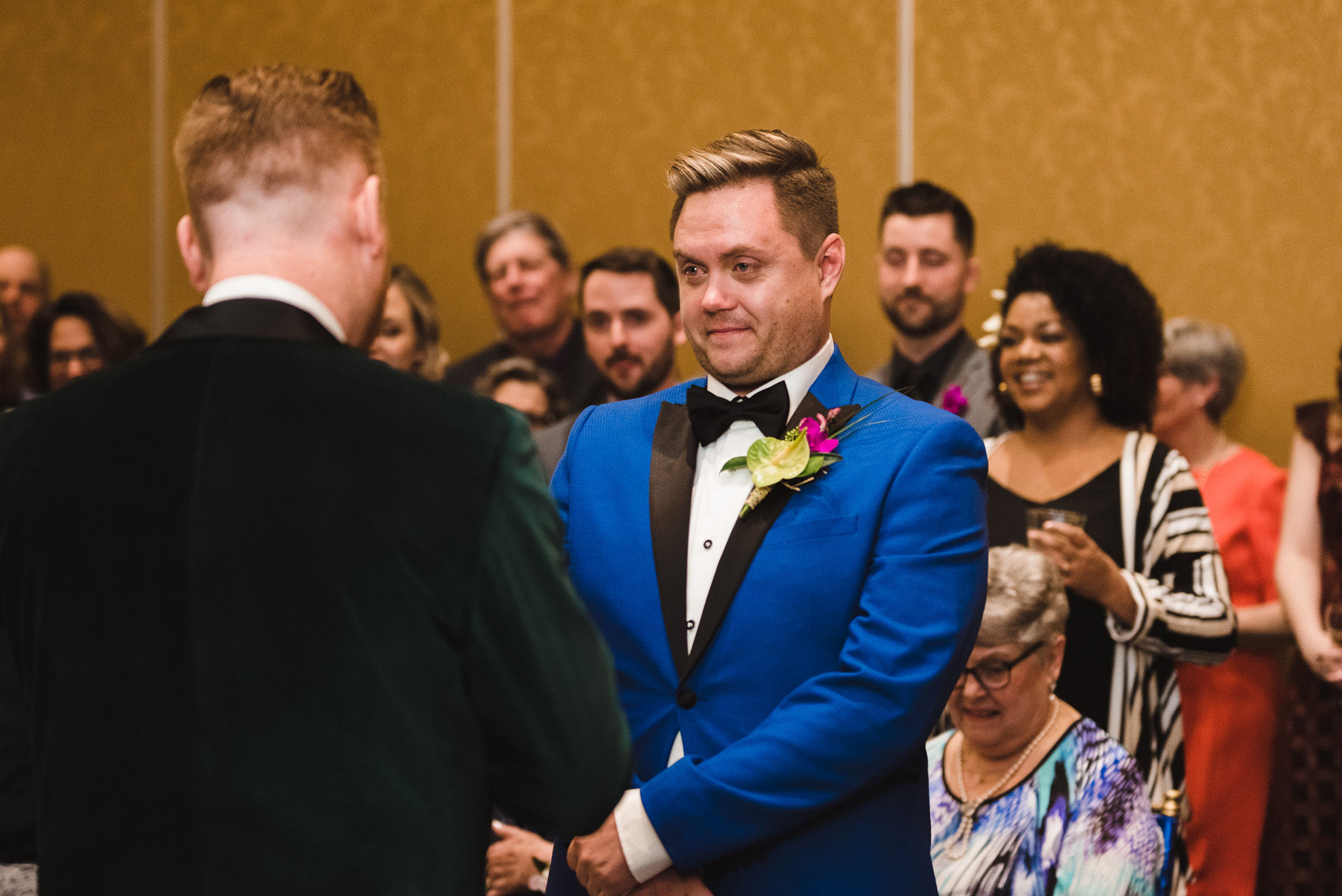 groom in bright blue suit getting teary eyed during wedding ceremony at the Hilton Fallsview in Niagara Falls