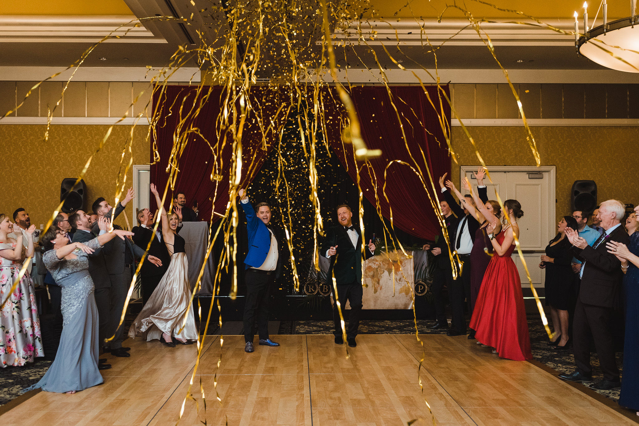 gold streamers shoot from a canon during the wedding reception at the Hilton Fallsview in Niagara Falls
