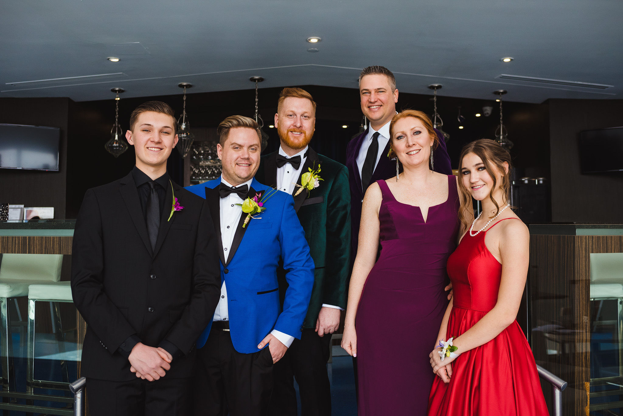 grooms standing with their family members before their wedding ceremony at the Hilton hotel in Niagara Falls 