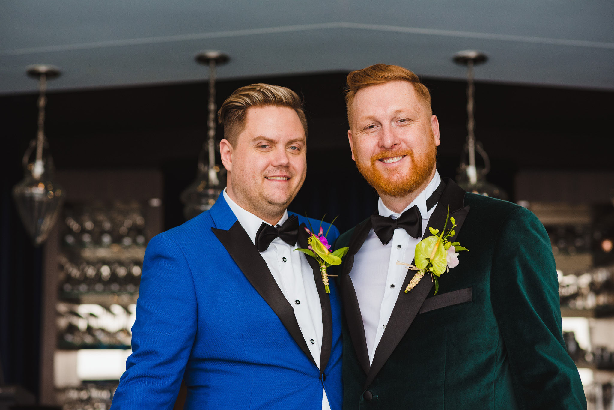 Grooms smiling and standing side by side before their wedding at the Hilton hotel in Niagara Falls