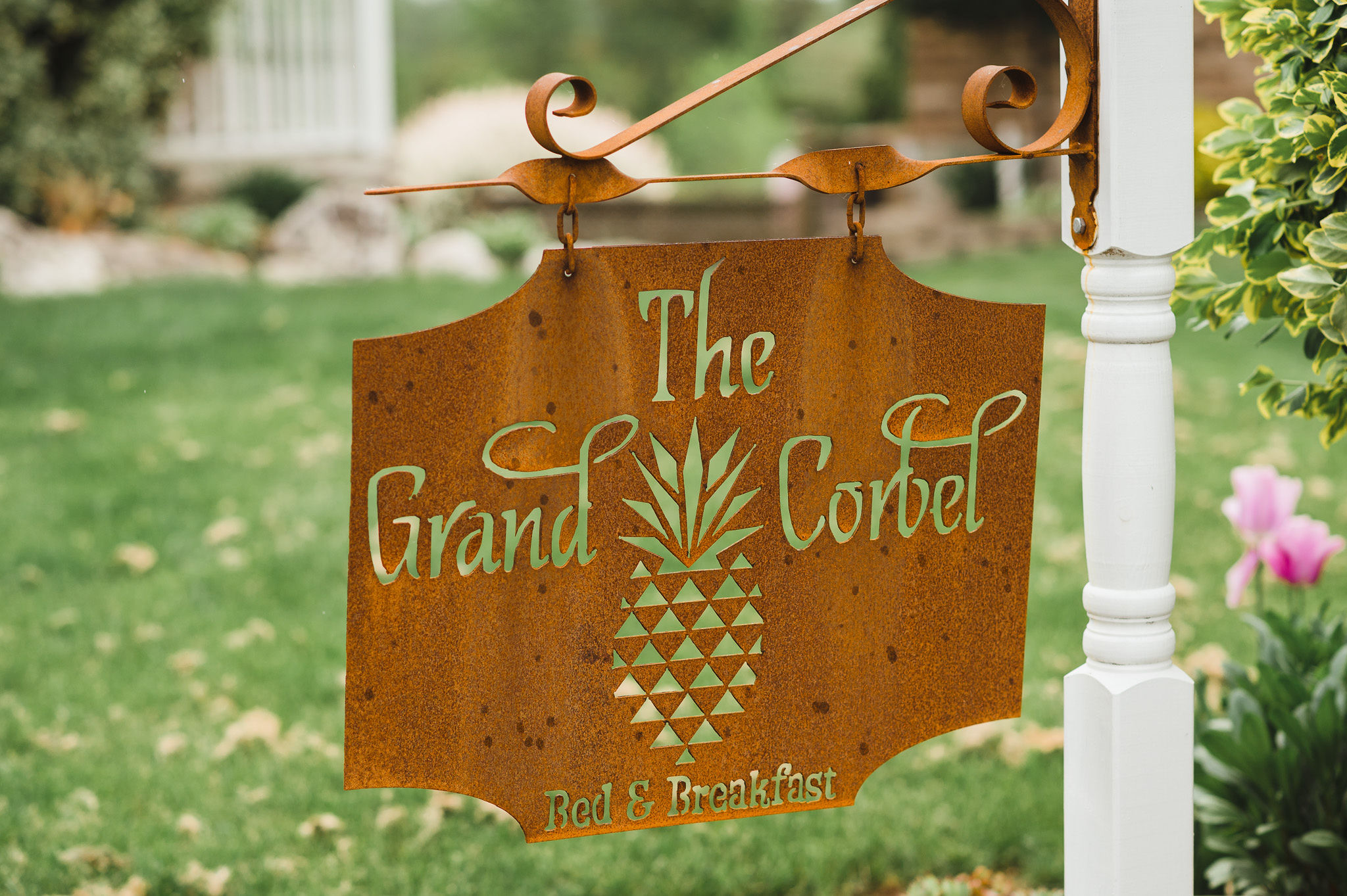 a brass sign for The Grand Corbet bed and breakfast with a pineapple design on it charming southern wedding at Ruthven Park National Historic Site 