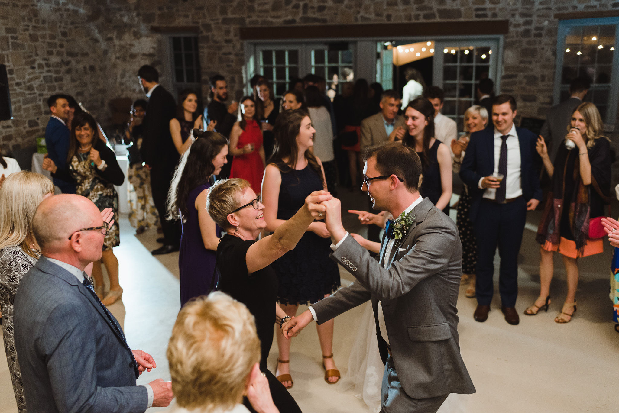 groom on the dance floor dancing with his wedding guests during his charming southern style wedding at Ruthven National Historic Site near Hamilton