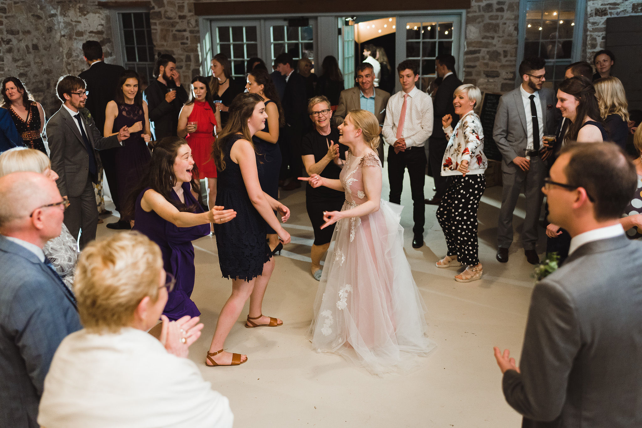 bride on the dance floor dancing with her wedding guests during her charming southern style wedding at Ruthven National Historic Site near Hamilton