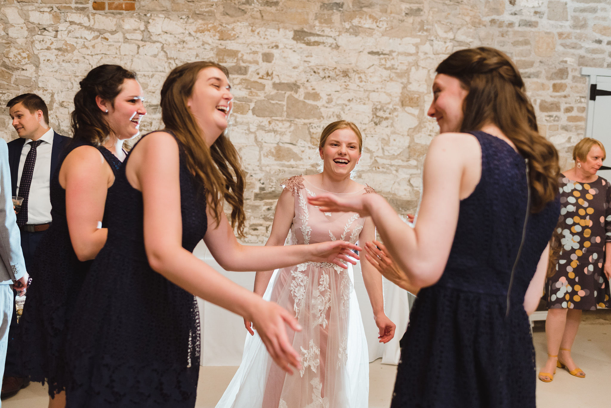 bride laughing and dancing with her bridesmaids during her charming southern style wedding at Ruthven National Historic Site near Hamilton