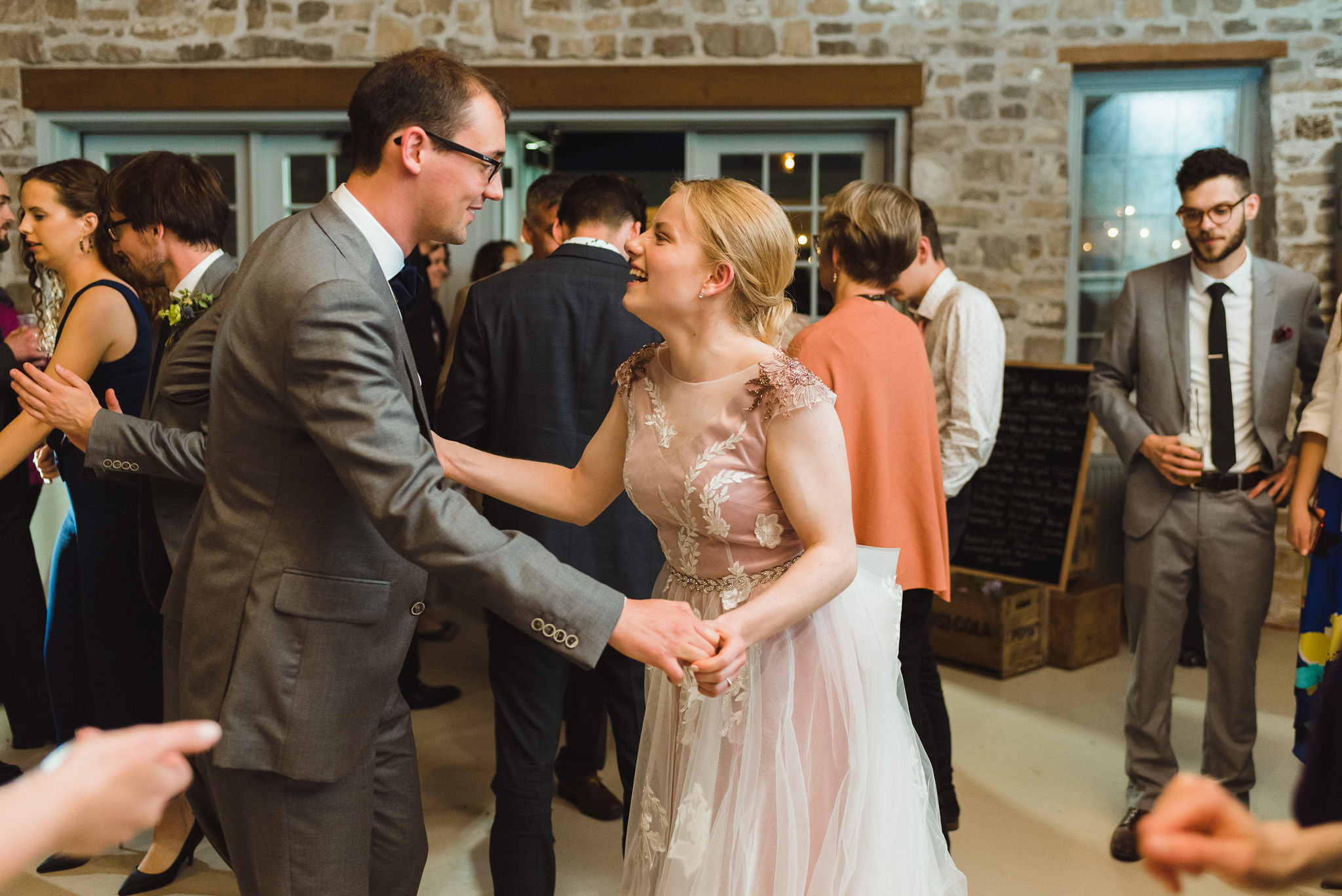 bride and groom laughing and dancing with their guests during their charming southern style wedding at Ruthven National Historic Site near Hamilton