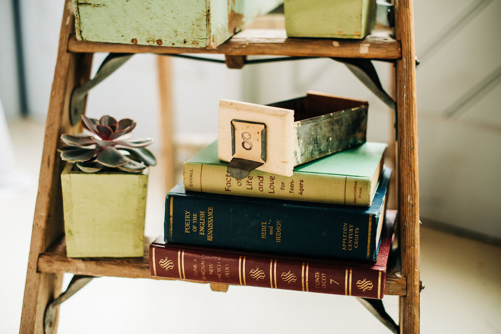 decorative vintage bookshelf with leather bound books set up for charming southern style wedding at Ruthven Park National Historic Site