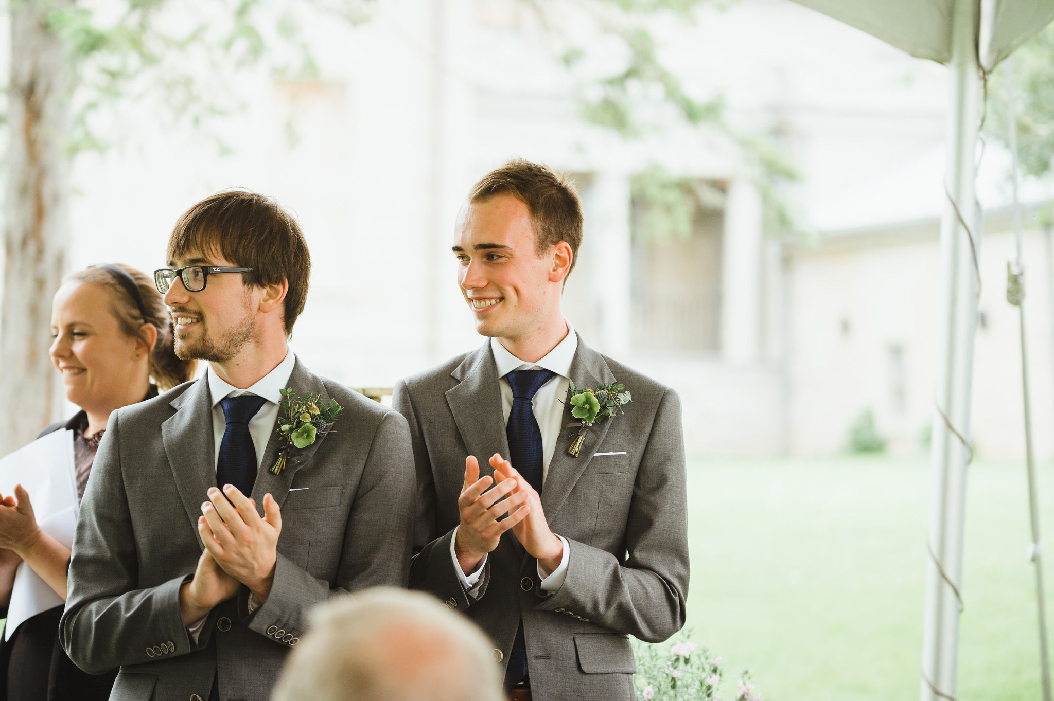 groomsmen in grey suits clapping as they watch a charming southern style wedding ceremony at Ruthven national historic site 