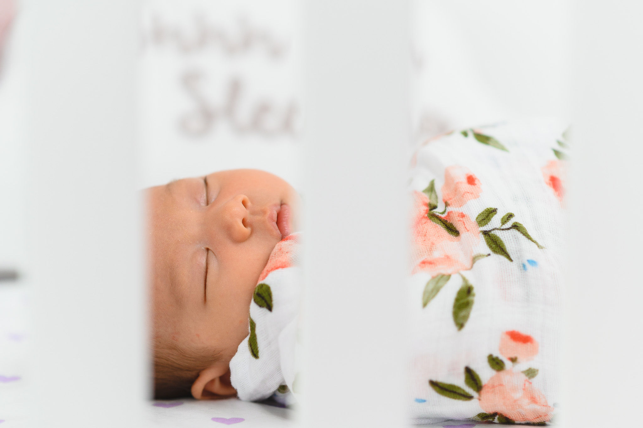 A baby swaddled in a floral blanket Toronto family photography How To Make Your Newborn Photoshoot Go Really Smoothly