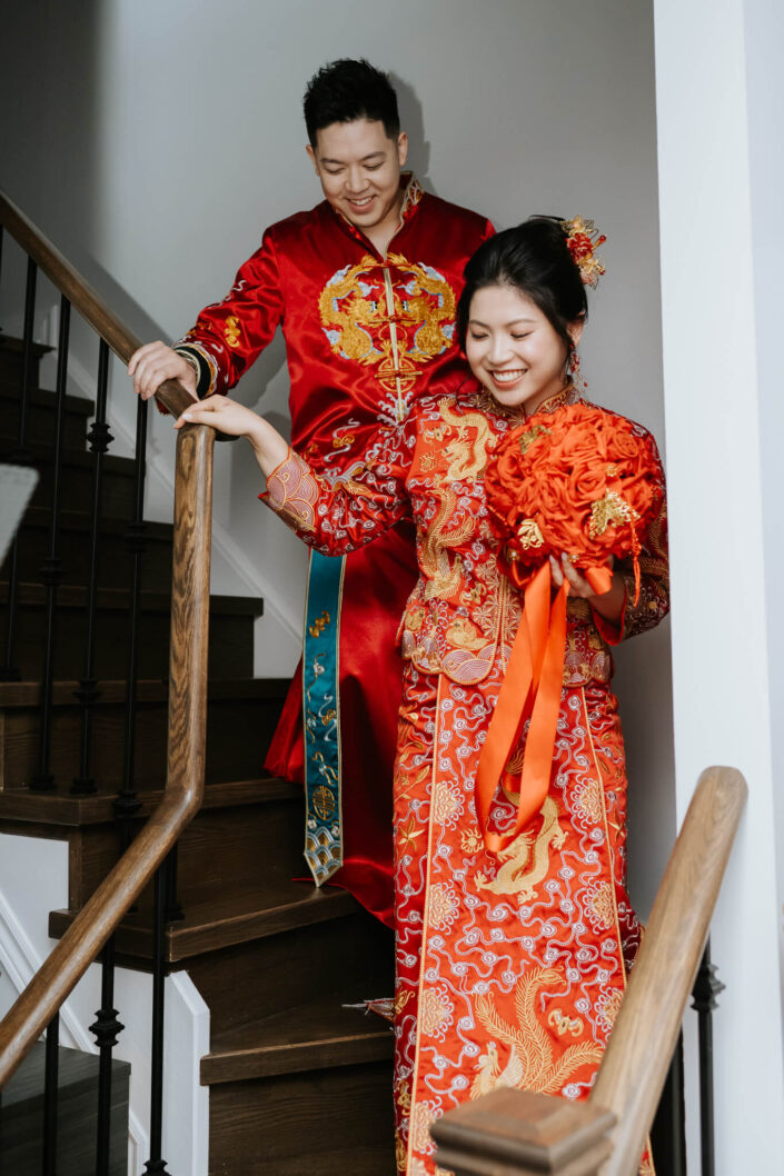 wedding couple climbing down stairs at home